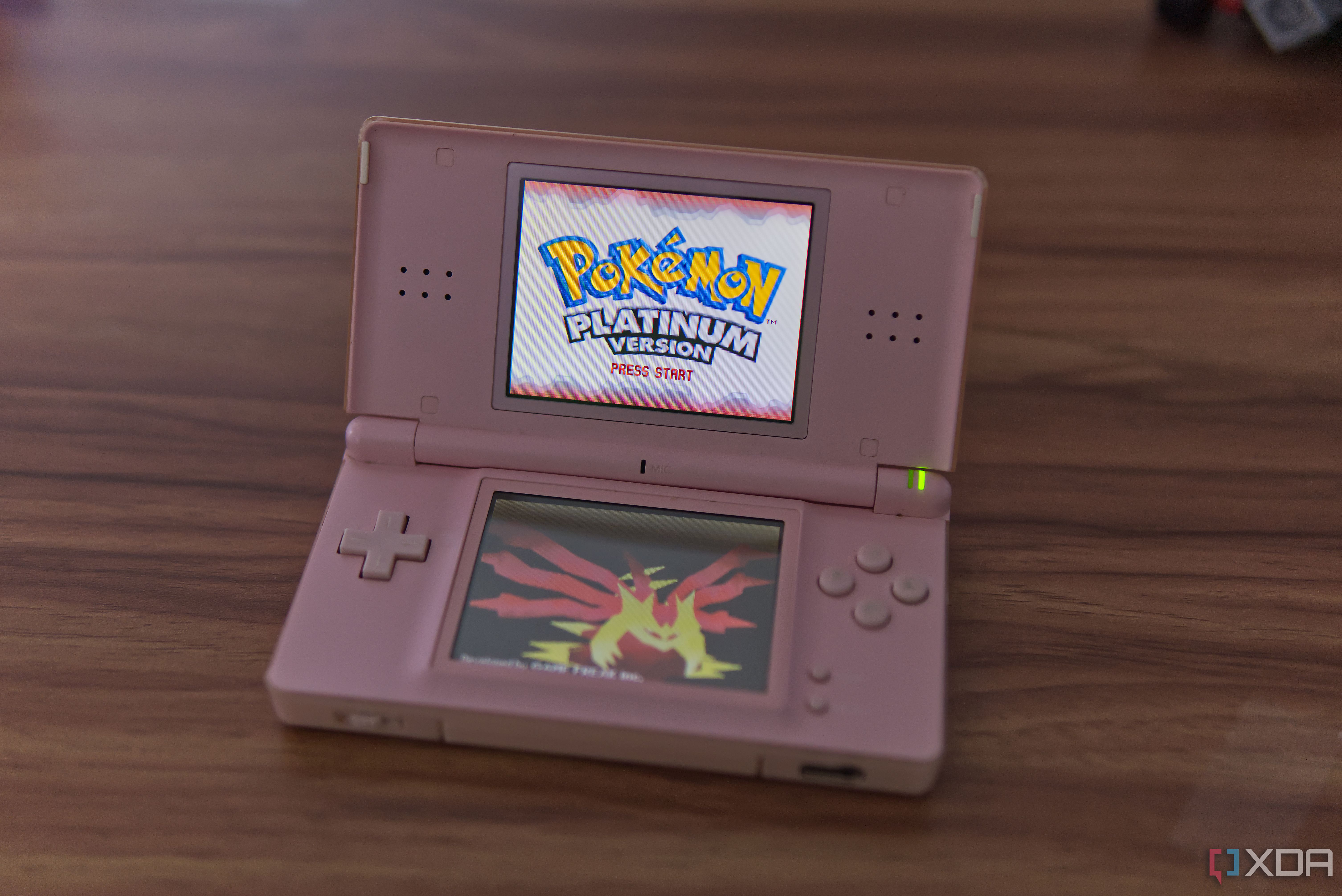 A Nintendo DS Lite showing the Pokémon Platinum title screen