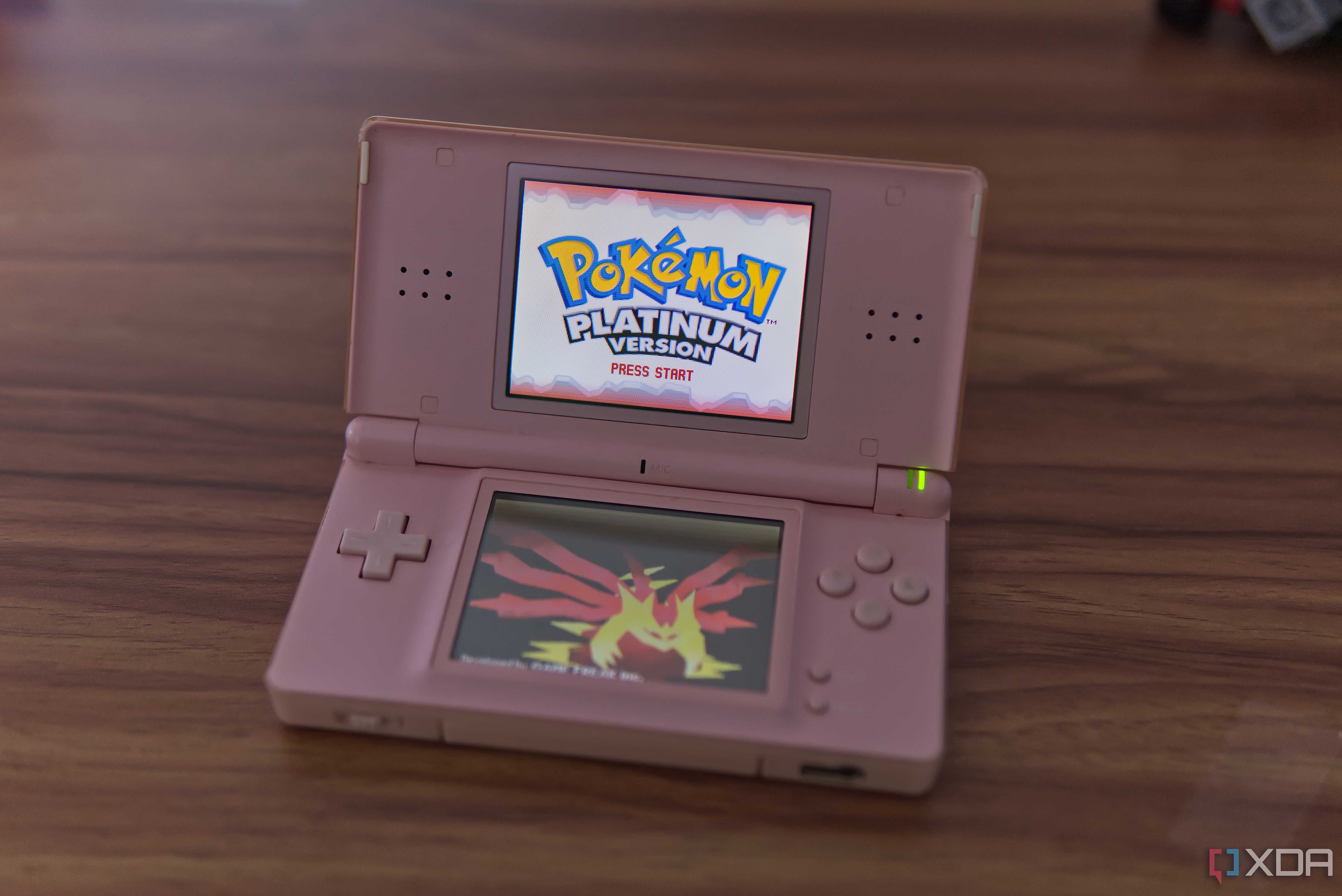A Nintendo DS Lite showing the Pokémon Platinum title screen