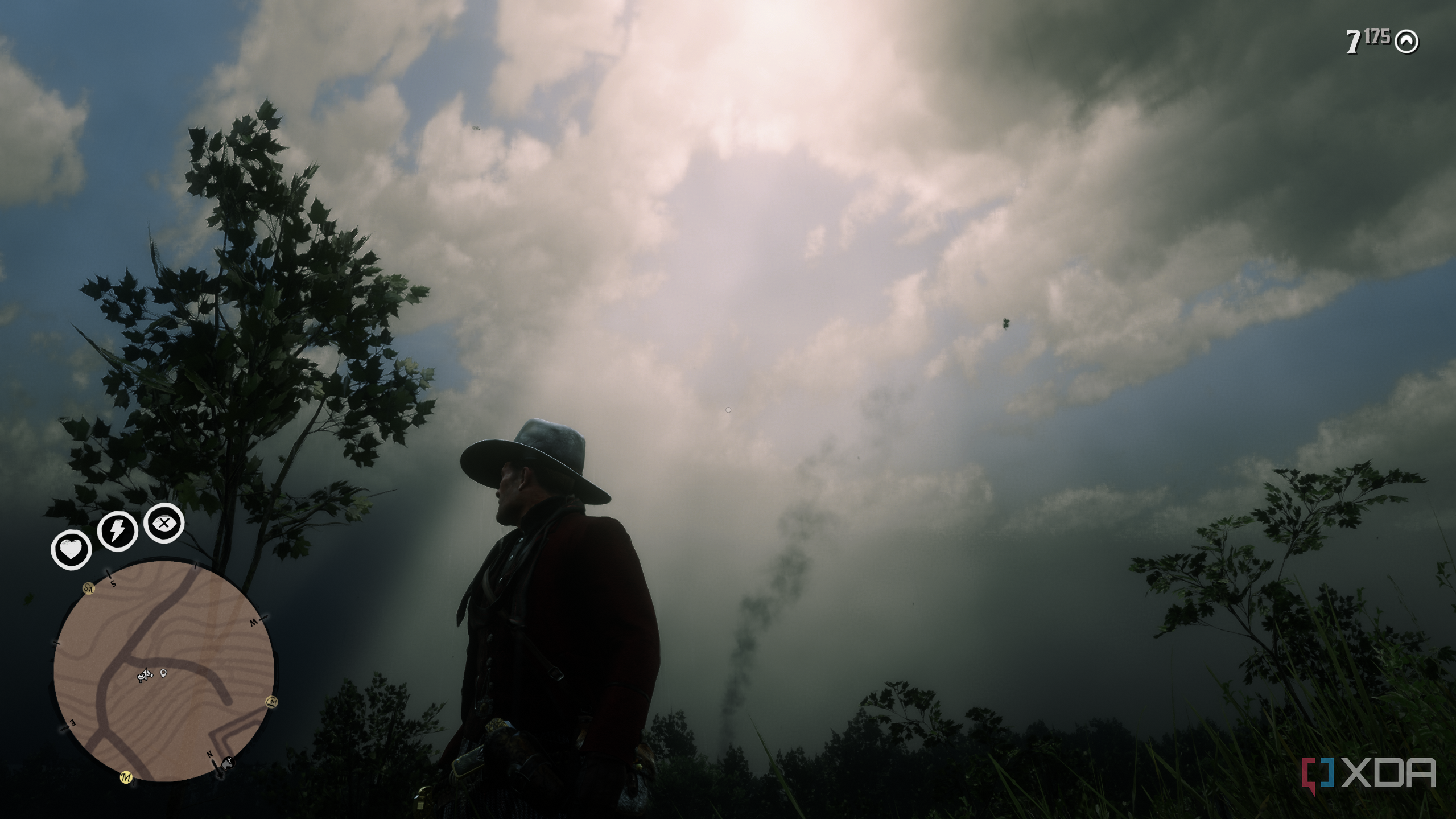 A gameplay screenshot from Red Dead Redemption 2 featuring low-level cumulus clouds. 