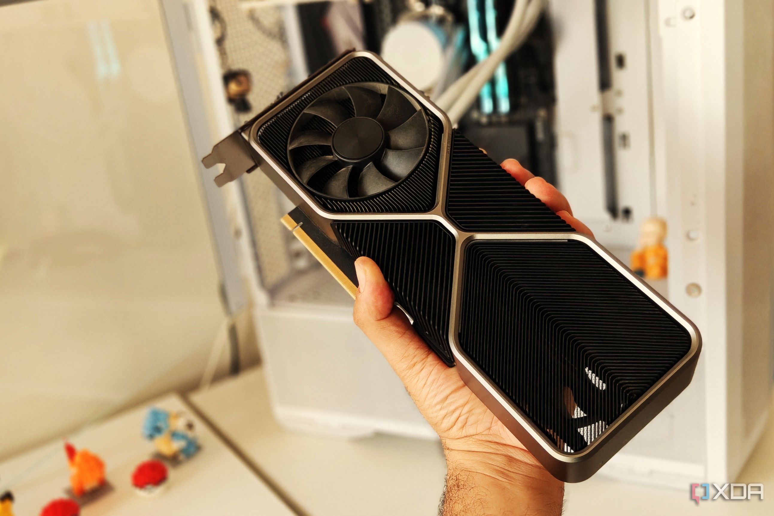 Close-up of a graphics card held in front of a gaming PC