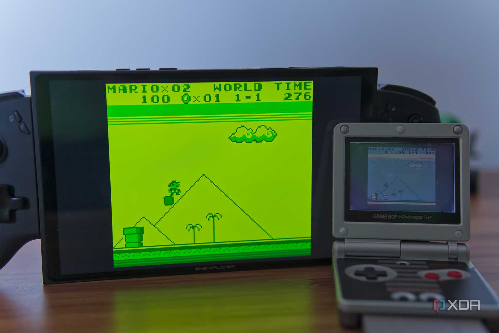 A gaming handheld next to a Game Boy Advance SP, bnoth running Super Mario Land