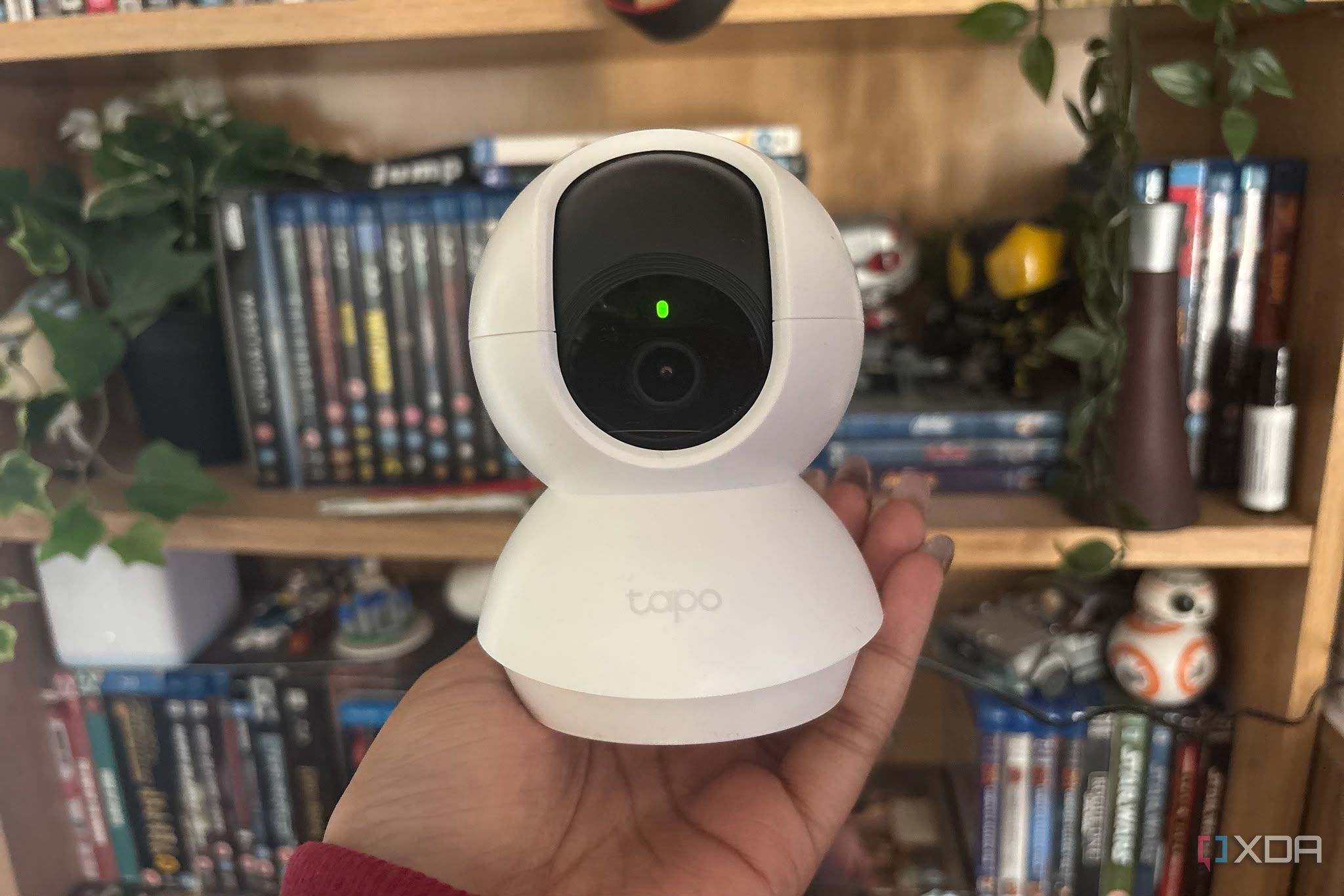 tapo camera being held up in front of shelf