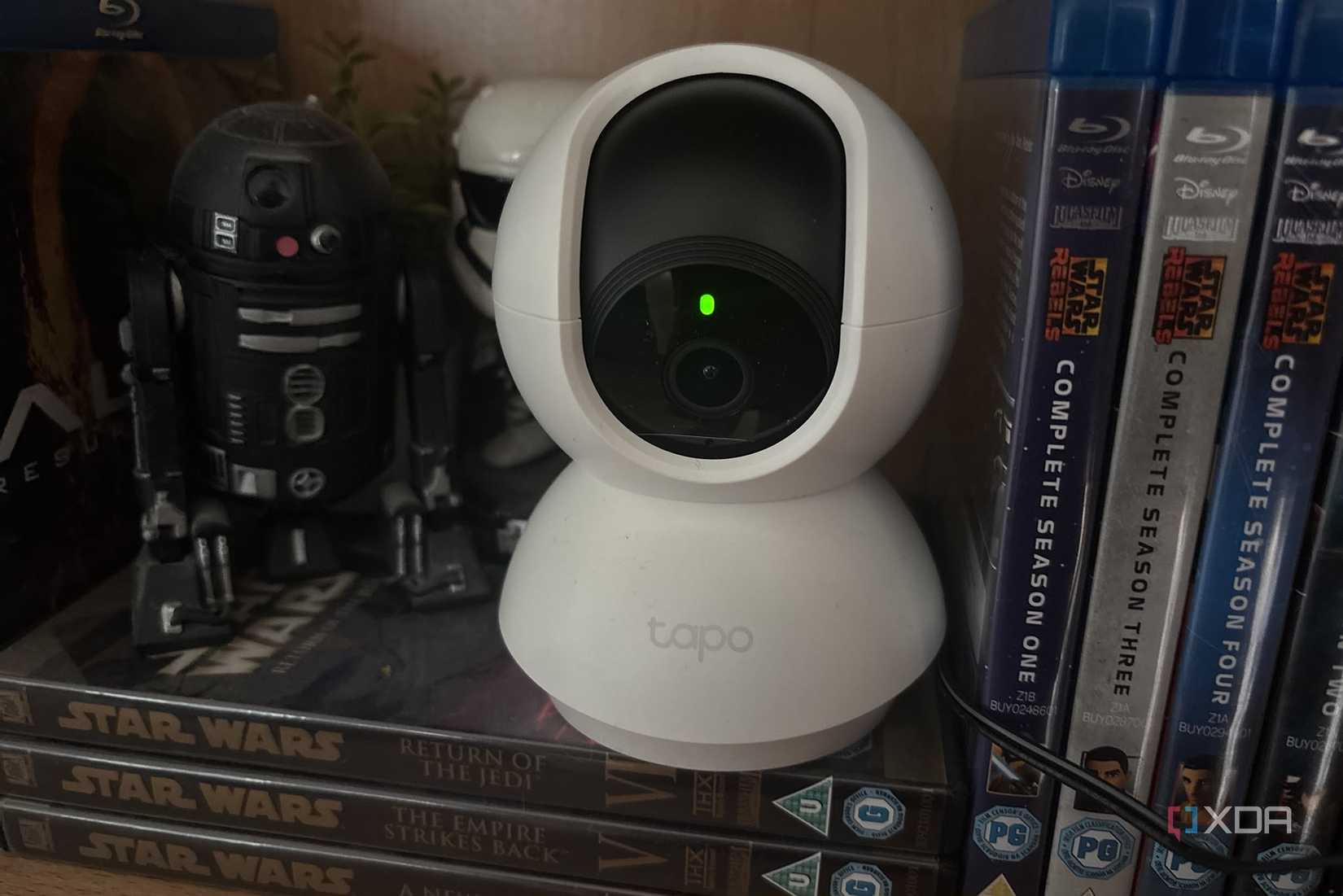 tapo camera on shelf next to figures
