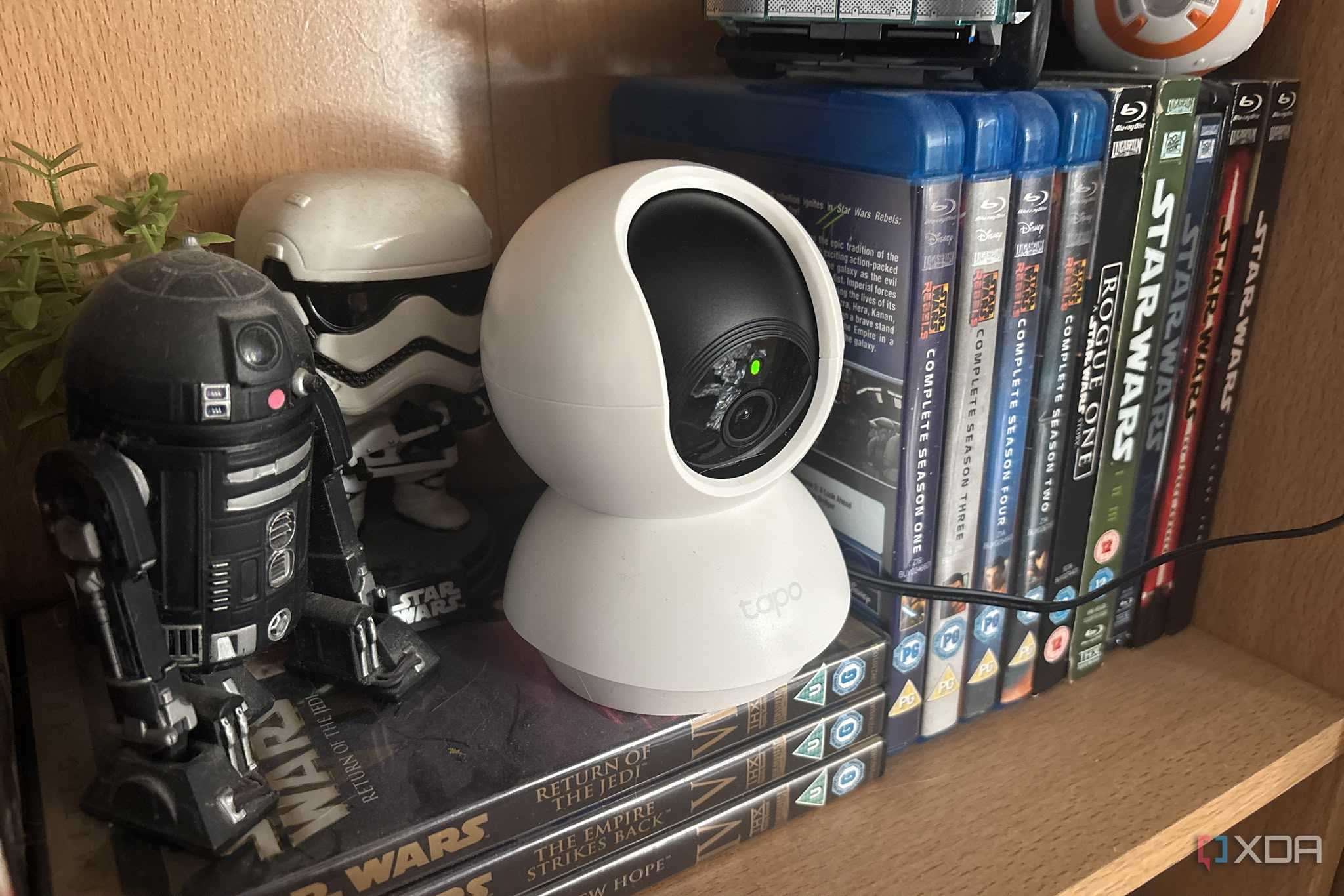 tapo camera on shelf with figures next to it