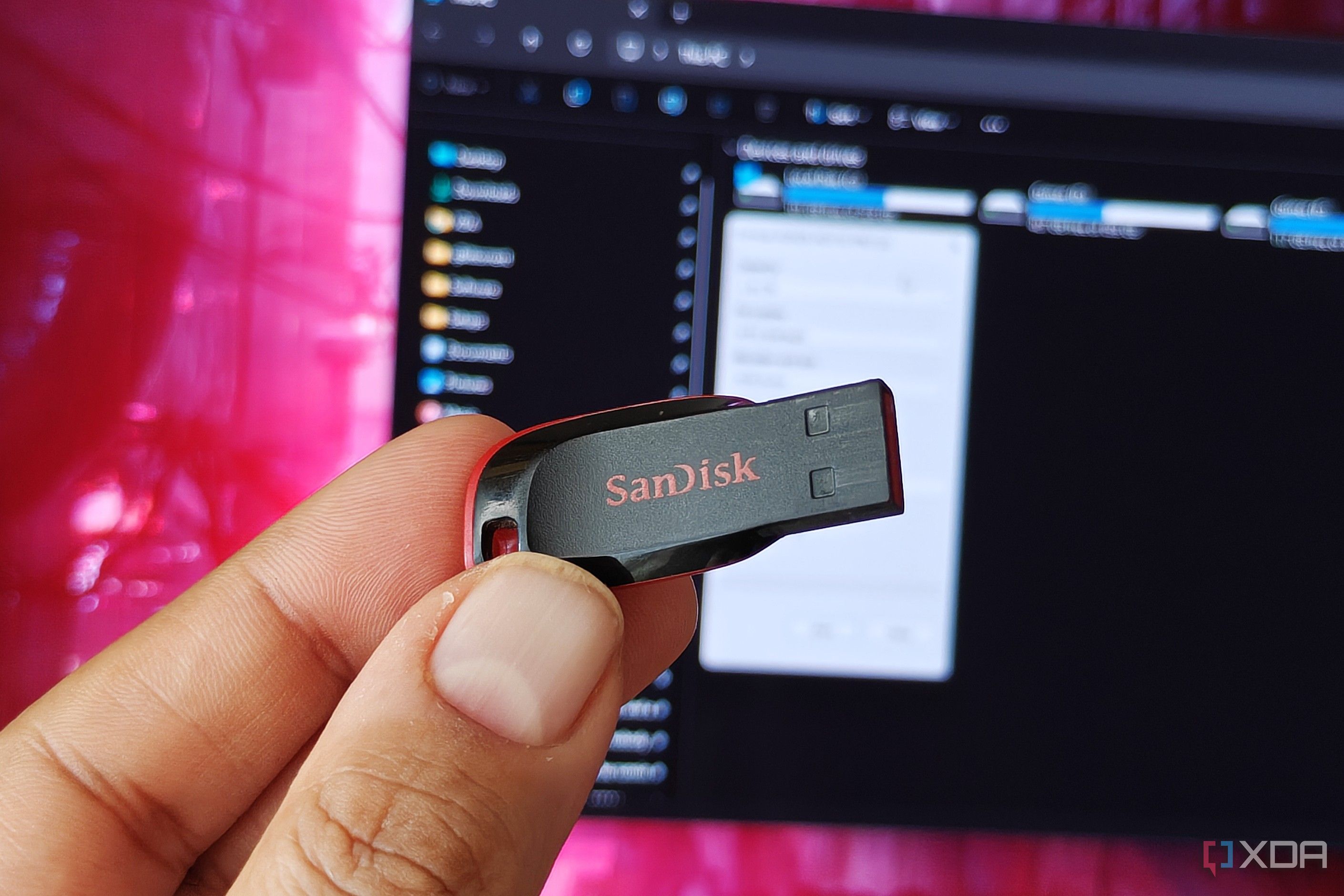 Holding a USB flash drive in front of a monitor