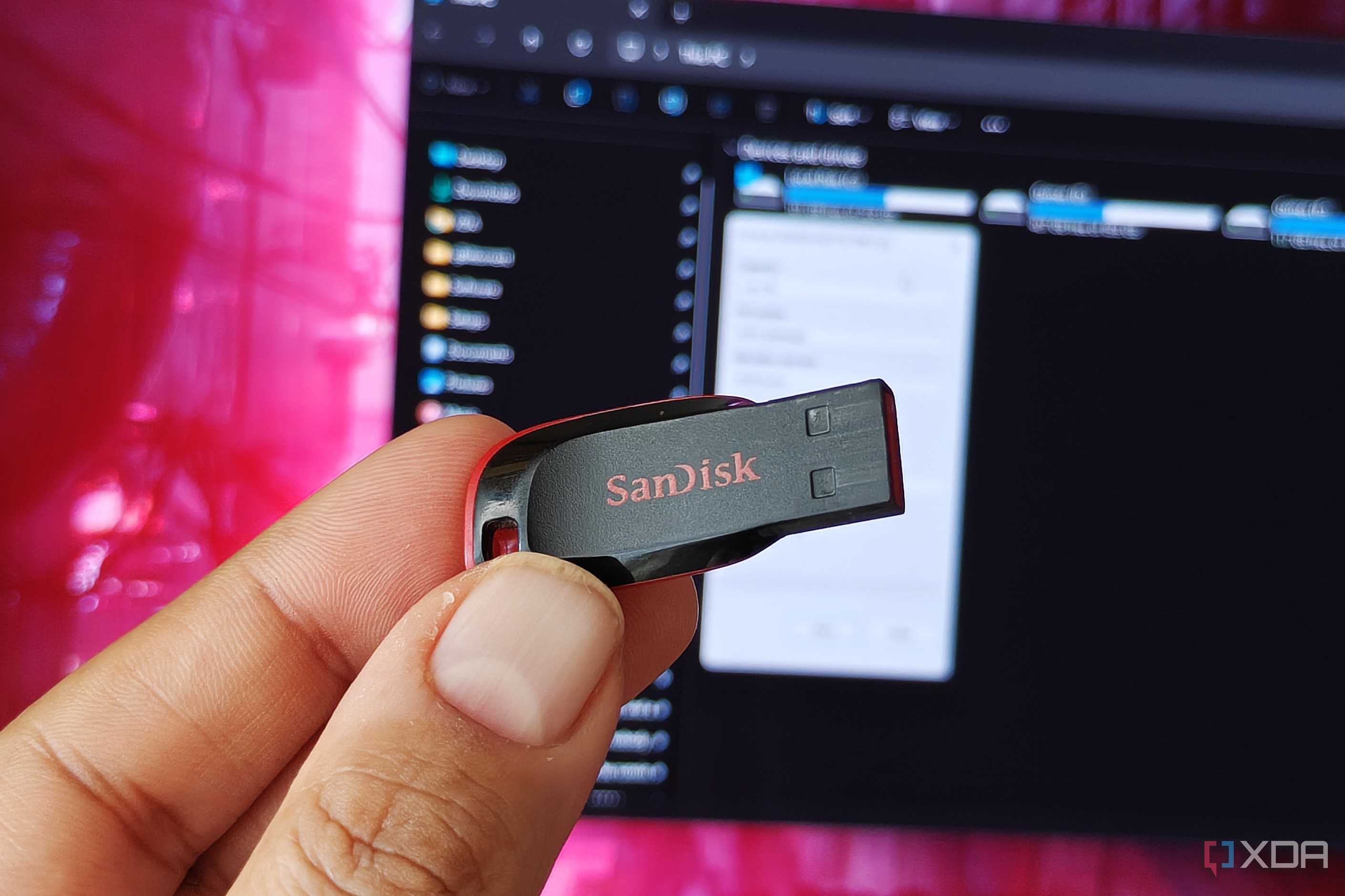 Holding a USB flash drive in front of a monitor