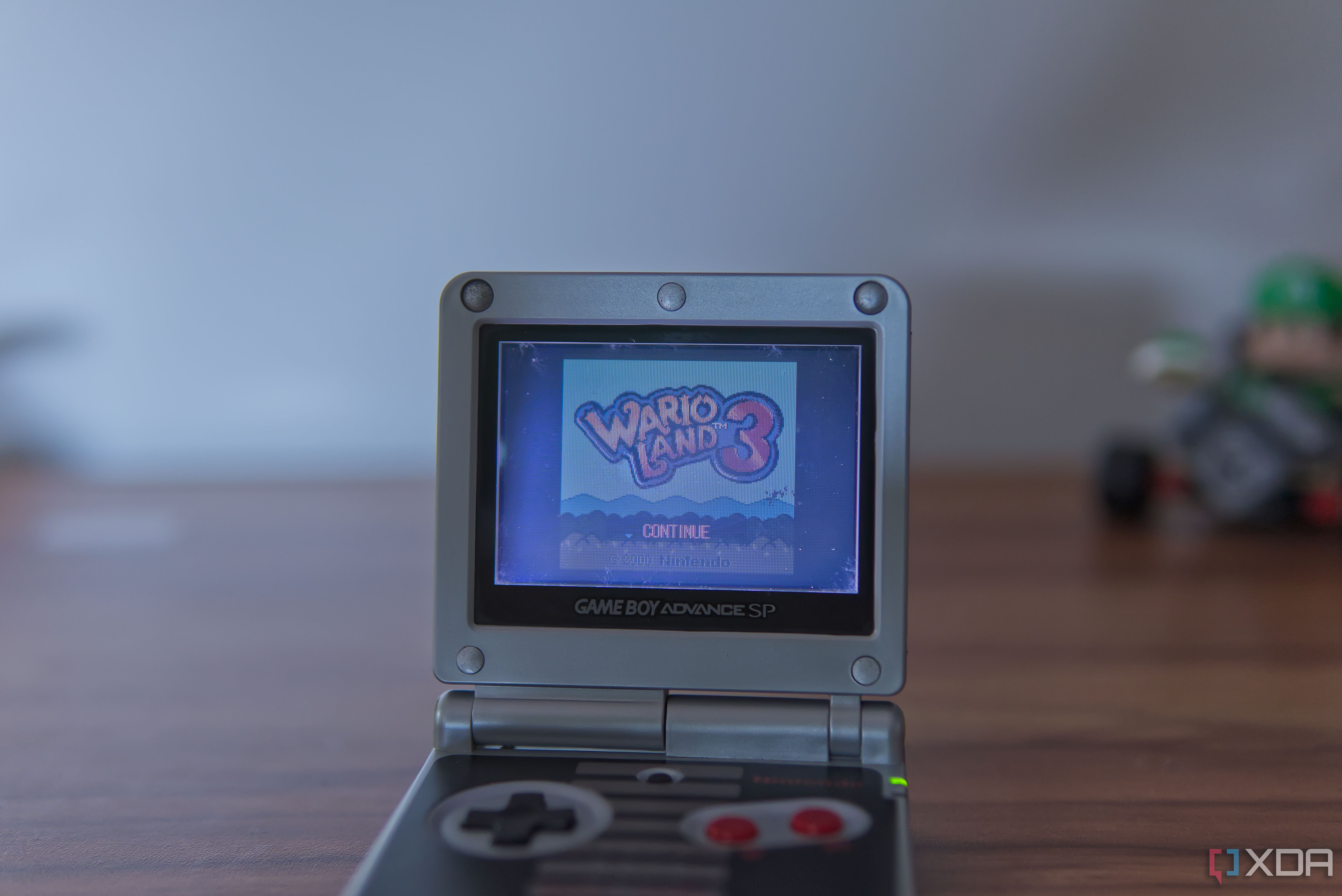 A Game Boy Advance SP displaying the title screen for Wario Land 3