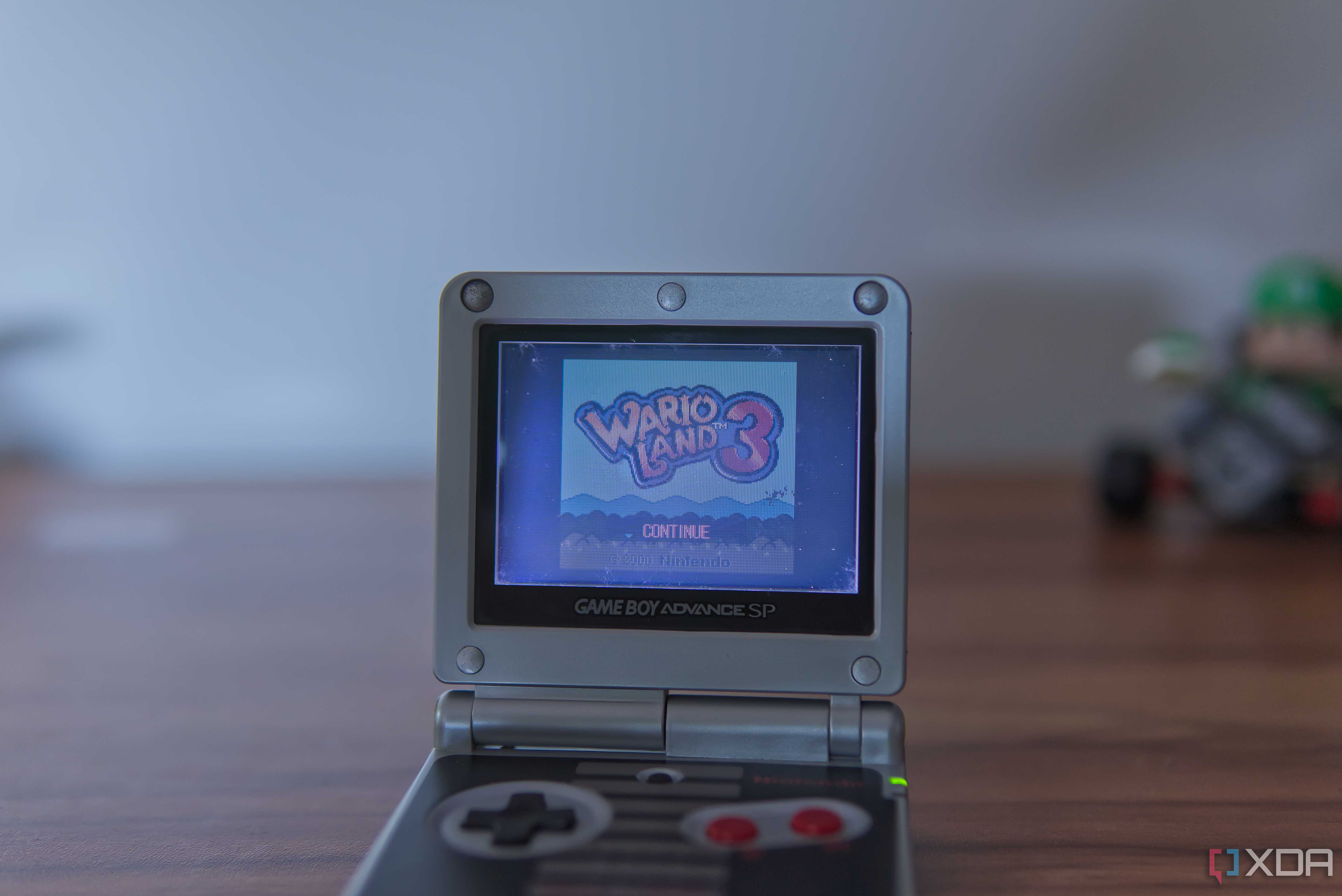 A Game Boy Advance SP displaying the title screen for Wario Land 3
