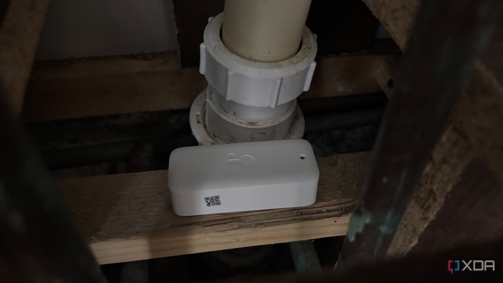 water sensor next to pipes under sink inside cupboard