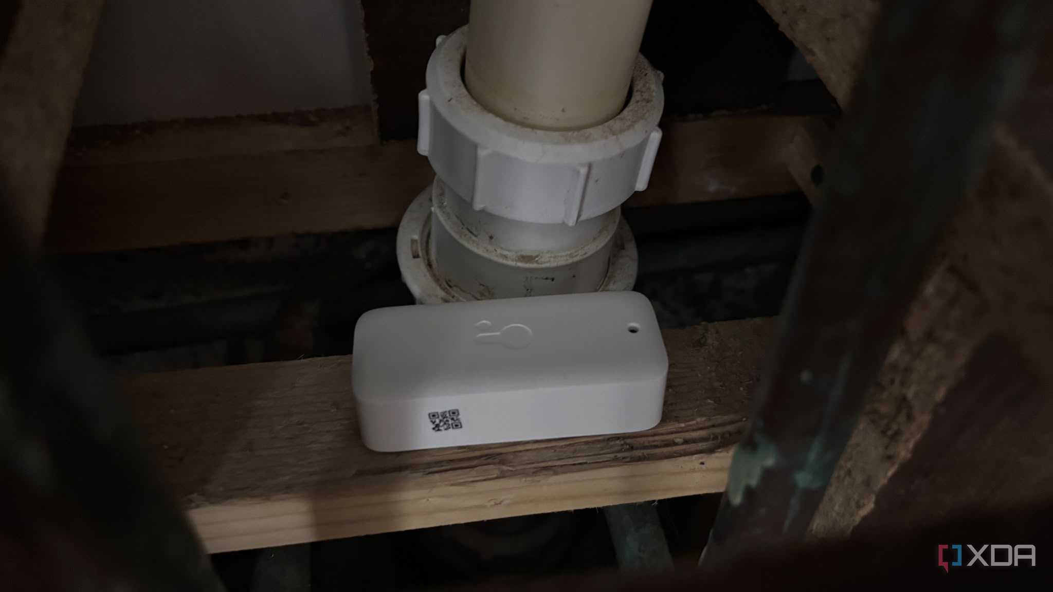 water sensor next to pipes under sink inside cupboard