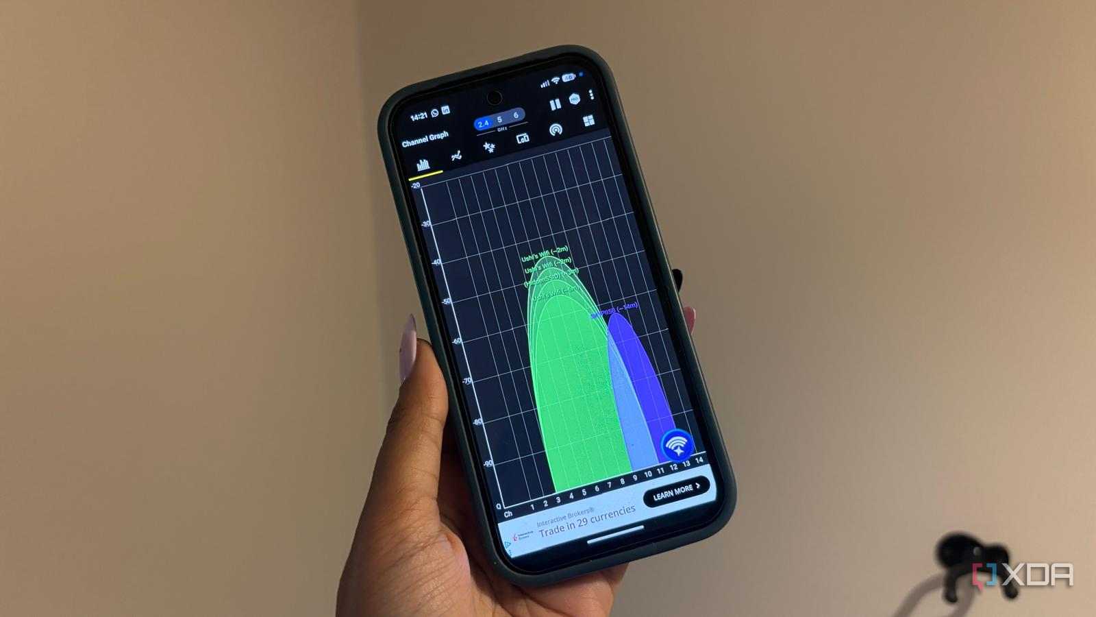 Wi-Fi analyzer app in use being held up on white background