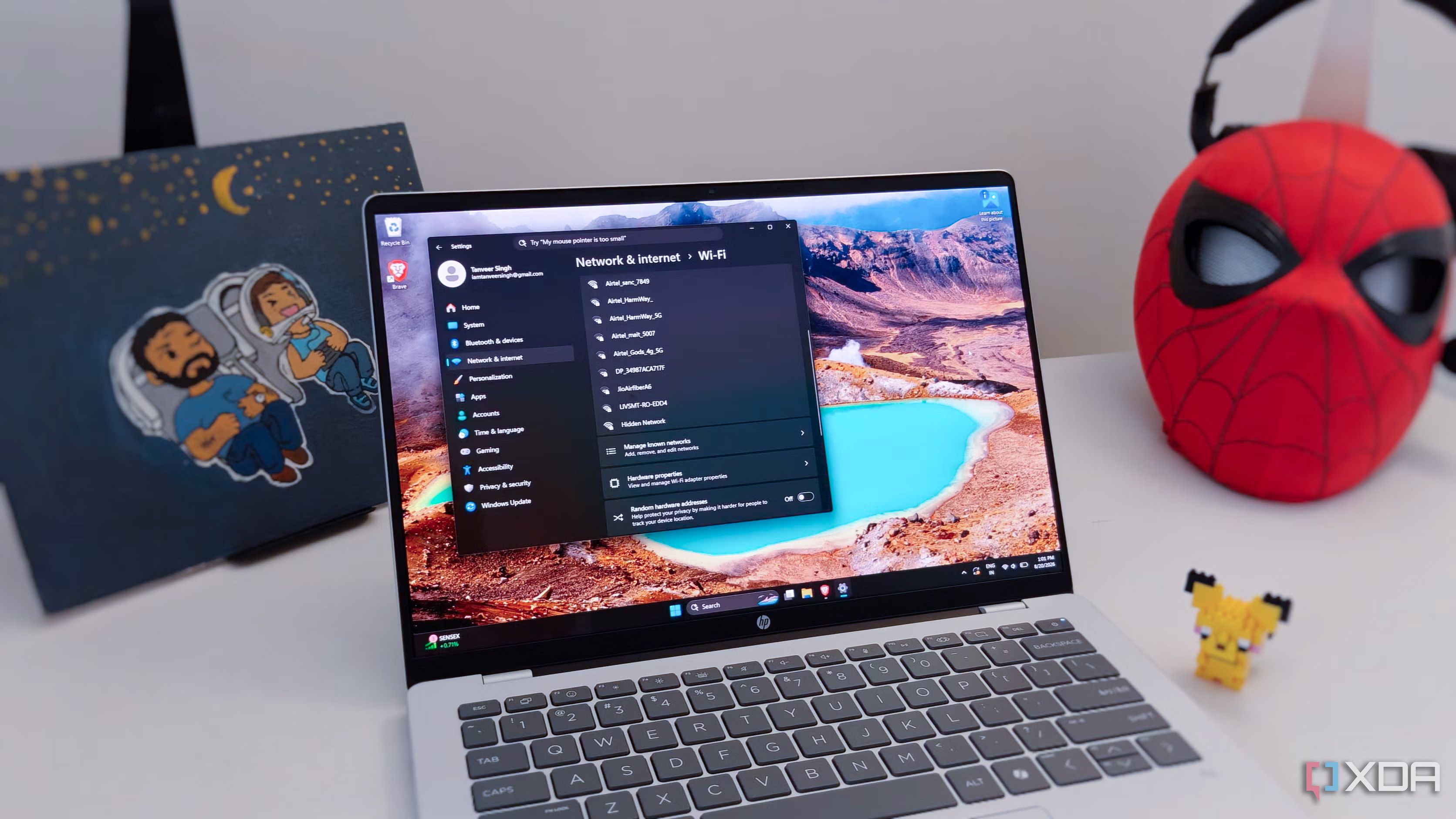 A Windows laptop next to some figurines on a white desk